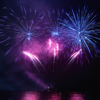 Colorful holiday fireworks on the black sky background