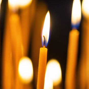 Light of candles in the church on the black background