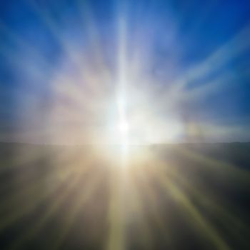Abstract sunset- shining sun with sunbeams on the blue sky background