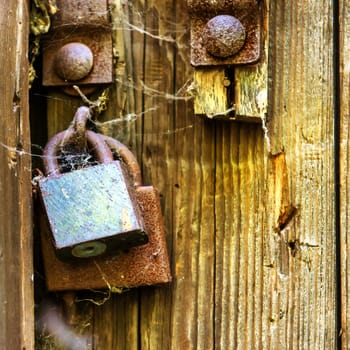 Retro wooden door with old rusty lock