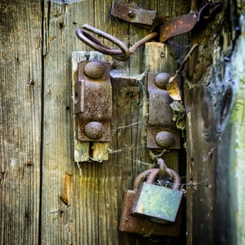 Retro wooden door with old rusty lock