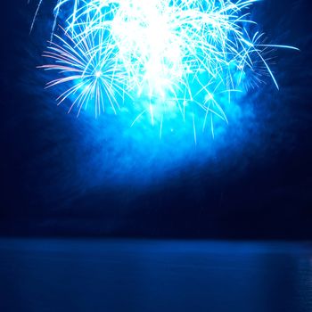 Blue colorful fireworks on the black sky background