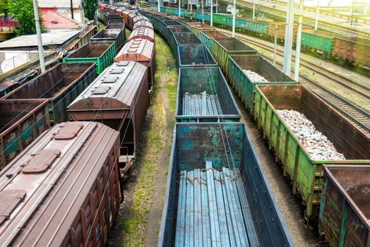 Many trains with cargo wagons on the railroad