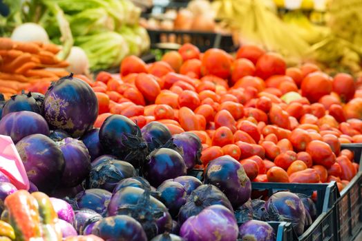 Fresh vegetables on the market. Red cabbage and tomato.