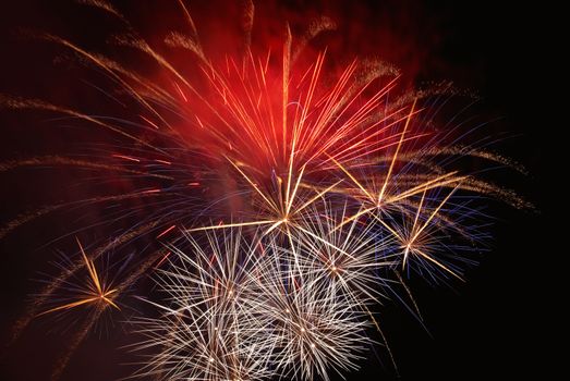 Blue colorful fireworks on the black sky background. Holiday celebration.