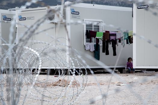 GREECE, Skaramagas: As thousands of refugees remain stranded in Greece, barbed wire surrounds storage containers serving as homes for 1,000 people at a new camp in Skaramagas, near Athens on April 14, 2016. They have just been relocated here after being stranded at the port of Piraeus, where they originally landed.
