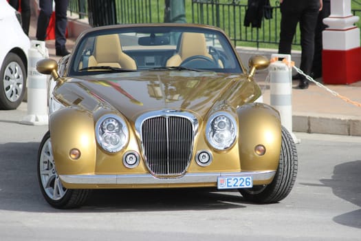 Monte-Carlo, Monaco - April 6, 2016: Golden Mitsuoka Roadster Parked in Front of the Monte-Carlo Casino in Monaco