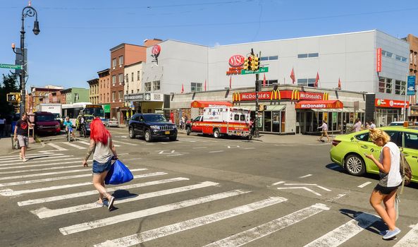 Brooklyn, New York - August 29, 2014: Pedestrians walking on the crossing at center of Greenpoint.