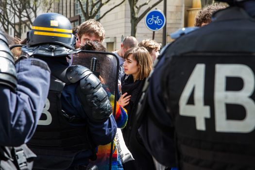 FRANCE, Paris: Protesters face riot policemen as hundreds demonstrate against the French government's proposed labour law reforms on April 14, 2016 in Paris. Fresh strikes by unions and students are being held across France against proposed reforms to France's labour laws, heaping pressure on President Francois Hollande who suffered a major defeat over constitutional reforms on March 30.