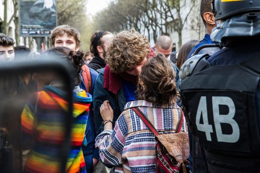 FRANCE, Paris: A couple kisses as hundreds demonstrate against the French government's proposed labour law reforms on April 14, 2016 in Paris. Fresh strikes by unions and students are being held across France against proposed reforms to France's labour laws, heaping pressure on President Francois Hollande who suffered a major defeat over constitutional reforms on March 30.