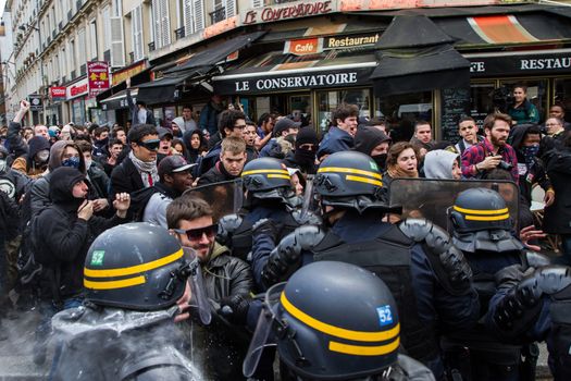 FRANCE, Paris: Protesters face riot policemen as hundreds demonstrate against the French government's proposed labour law reforms on April 14, 2016 in Paris. Fresh strikes by unions and students are being held across France against proposed reforms to France's labour laws, heaping pressure on President Francois Hollande who suffered a major defeat over constitutional reforms on March 30.