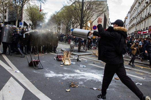 FRANCE, Paris: A riot policeman throws tear gas at a protester who throws a projectile at the police as hundreds demonstrate against the French government's proposed labour law reforms on April 14, 2016 in Paris. Fresh strikes by unions and students are being held across France against proposed reforms to France's labour laws, heaping pressure on President Francois Hollande who suffered a major defeat over constitutional reforms on March 30.