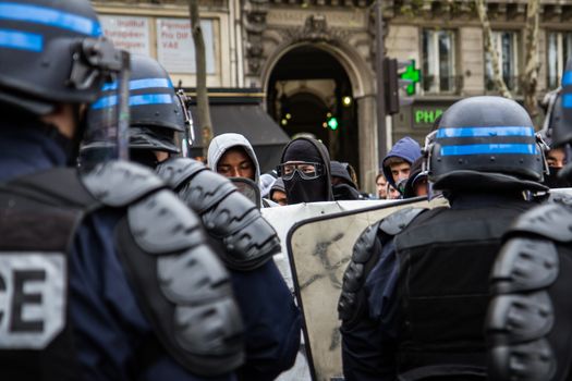 FRANCE, Paris: Protesters face riot policemen Hundreds demonstrate against the French government's proposed labour law reforms on April 14, 2016 in Paris. Fresh strikes by unions and students are being held across France against proposed reforms to France's labour laws, heaping pressure on President Francois Hollande who suffered a major defeat over constitutional reforms on March 30.