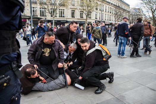 FRANCE, Paris: Policemen arrest a man as hundreds demonstrate against the French government's proposed labour law reforms on April 14, 2016 in Paris. Fresh strikes by unions and students are being held across France against proposed reforms to France's labour laws, heaping pressure on President Francois Hollande who suffered a major defeat over constitutional reforms on March 30.