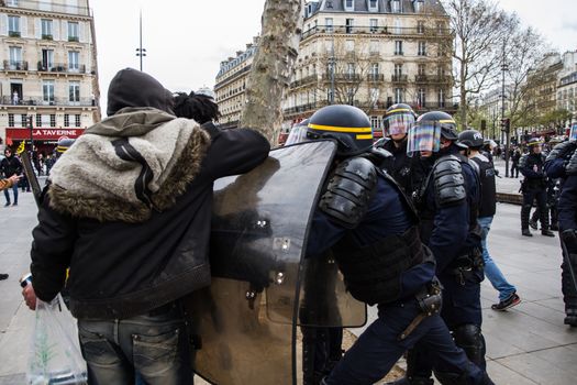 FRANCE, Paris: Protesters and riot policemen fight with each other as hundreds demonstrate against the French government's proposed labour law reforms on April 14, 2016 in Paris. Fresh strikes by unions and students are being held across France against proposed reforms to France's labour laws, heaping pressure on President Francois Hollande who suffered a major defeat over constitutional reforms on March 30.