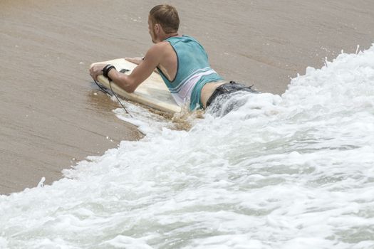 Man Body Boarder surfing on the waves Sea beach