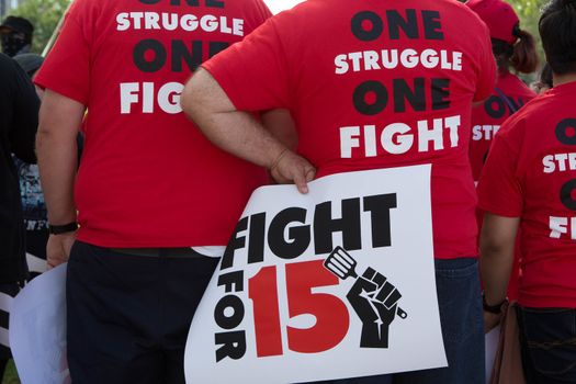 UNITED STATES, Phoenix: Protesters wear tshirts reading 'one struggle one fight' as hundreds of workers and supports took to the streets in Phoenix, Arizona on April 14, 2016 to call for a national minimum wage increase to  an hour. 
