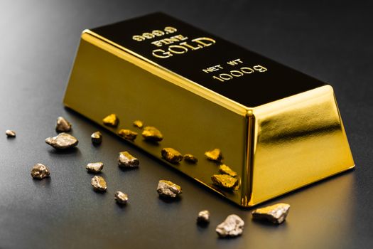 gold bullion and nuggets on a dark background