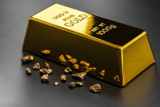 gold bullion and nuggets on a dark background