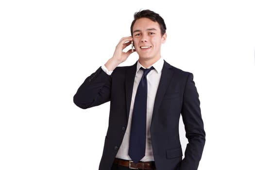 A young caucasian male businessman smiling holding a mobile phone looking at camera.