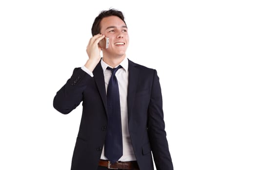 A young caucasian male businessman smiling holding a mobile phone looking away from camera.