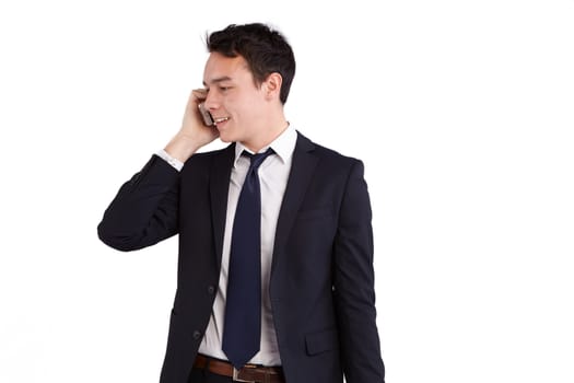 A young caucasian male businessman smiling holding a mobile phone looking away from camera.