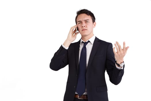 A young caucasian male businessman frowns with raised hand while holding a mobile phone looking away from camera.