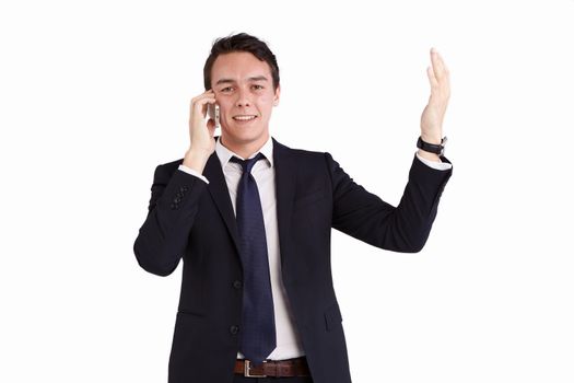 A young caucasian male businessman smiling with raised hand holding a mobile phone looking at camera.
