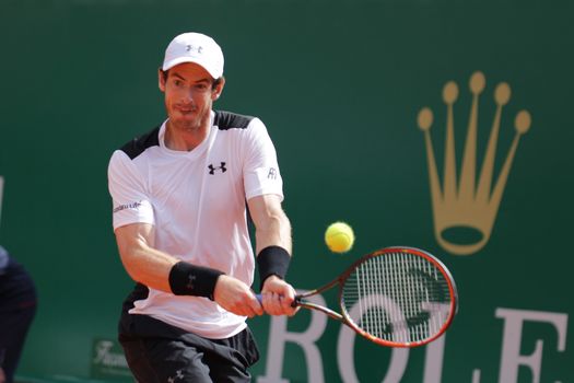 MONACO, Monte-Carlo: Andy Murray hits a return to Canada's Milos Raonic during their tennis match at the Monte-Carlo ATP Masters Series tournament on April 15, 2016 in Monaco. Britain's Andy Murray is through to the Monte Carlo Masters semi-finals following an impressive win over Canadian Milos Raonic.