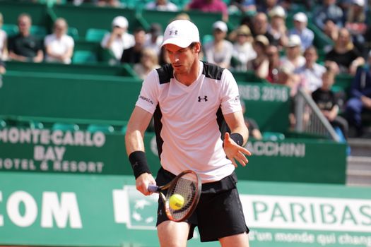 MONACO, Monte-Carlo: Andy Murray hits a return to Canada's Milos Raonic during their tennis match at the Monte-Carlo ATP Masters Series tournament on April 15, 2016 in Monaco. Britain's Andy Murray is through to the Monte Carlo Masters semi-finals following an impressive win over Canadian Milos Raonic.