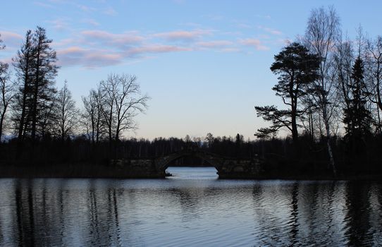 Humpback Bridge in Gatchina park, uniting the two islands and mirrored in White Lake. Leningrad region, December 2015