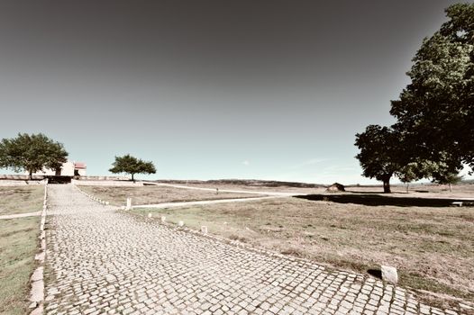 Small Rural Church on the Background of Modern Wind Turbines in Portugal, Retro Image Filtered Style