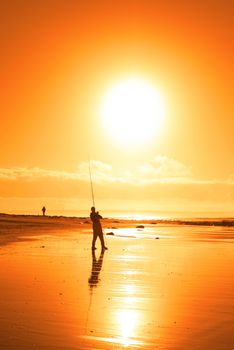 lone fisherman fishing on the beach in Ballybunion county Kerry Ireland