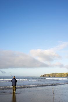 lone fisherman fishing on the beach in Ballybunion county Kerry Ireland