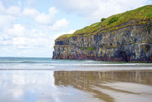 lone kayaker near the cliffs of ballybunion beach on the wild atlantic way ireland