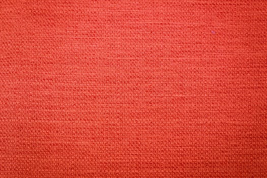 Rustic canvas fabric texture in orange color.