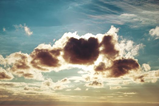 Beautiful blue sky with sunbeams and sun rays through the clouds.