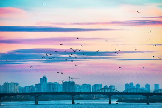 Spectacular sunset city view with bridge over Dnepr river. Kiev, Ukraine