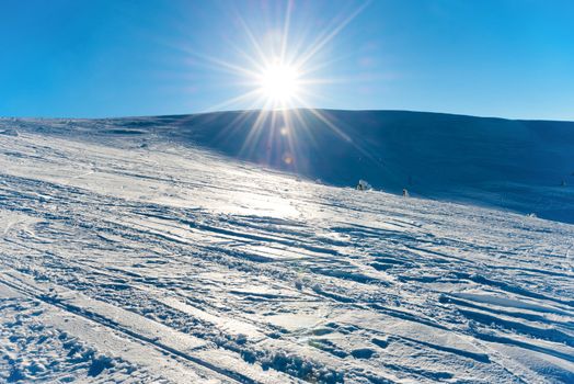 Winter is coming! Bright sun in the mountains covered with snow.