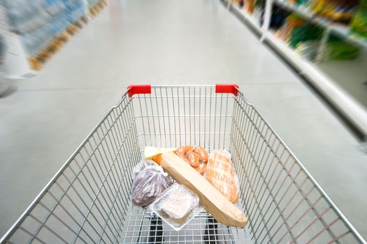 Shopping cart, trolley in a big supermarket with no people