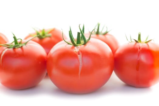 Group of red fresh tomatoes isolated on white background
