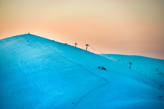 Sunset in winter mountains covered with snow