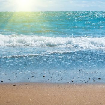 Blue sea, shining sun and beach with golden sand. Summer vacation background