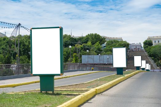 Many lightboxes in a row on the city street isolated on white