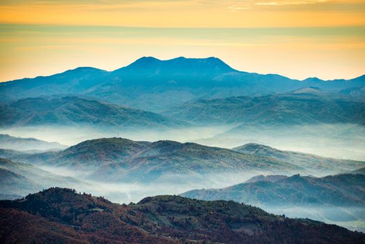 Beautiful sunset above the range of blue mountains