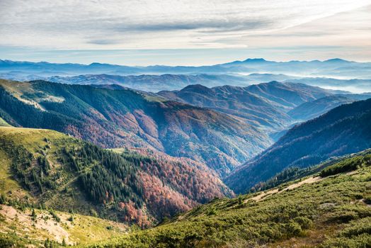 Green mountains and hills at orange sunset time