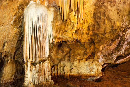 Inside of beautiful old dark cave with many stalactites. Grotte di Is Zuddas, Italy, Sardinia