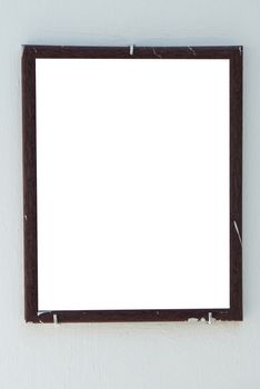 Vertical blank old wooden frame on the wall isolated on white