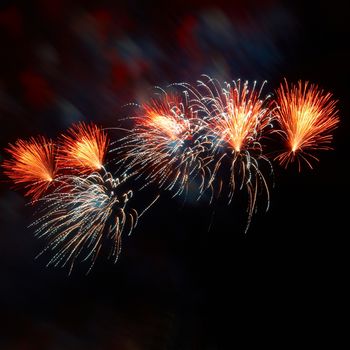 Beautiful colorful holiday fireworks on the black sky background
