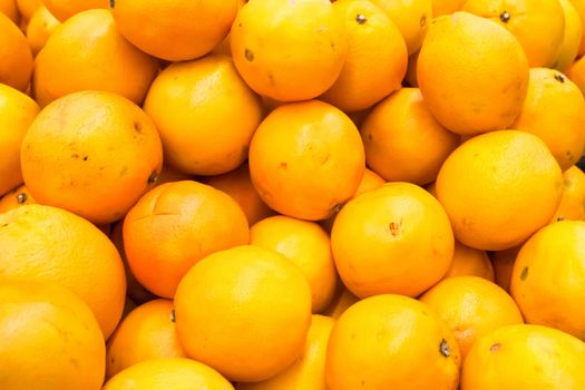 Pile of fresh oranges and mandarins at market